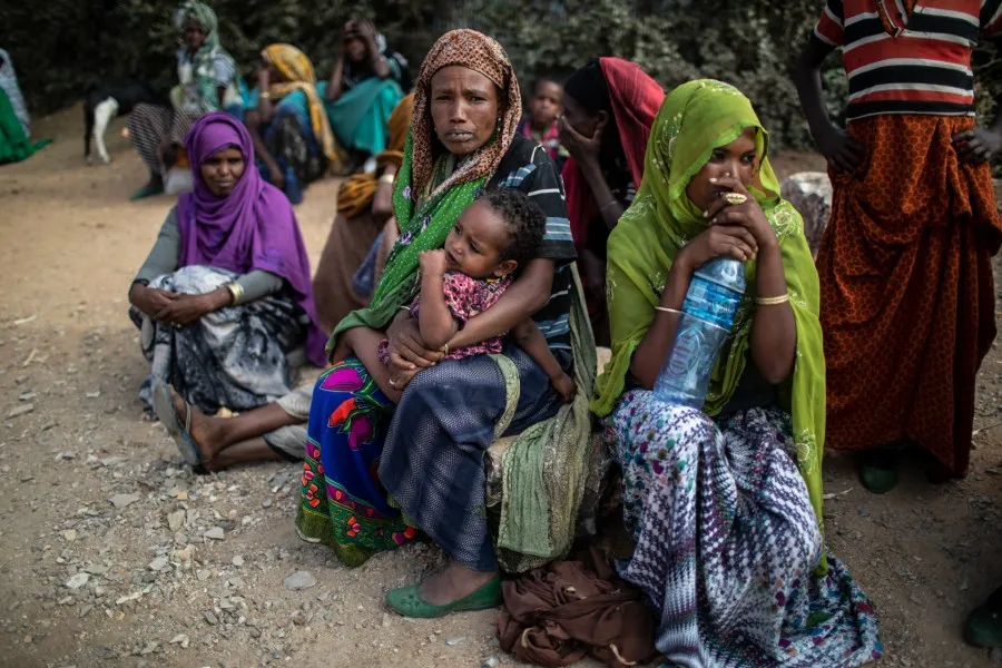 People wait outside a distribution point to receive aid rations in Oromia Region, Ethiopia, in February 2018?w=200&h=150